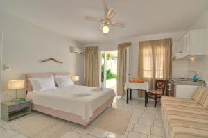 a bedroom with a bed and a living room at Hotel Rigas in Adamantas