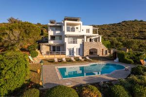 an aerial view of a house with a swimming pool at Wild Pear Villa in Agia Pelagia