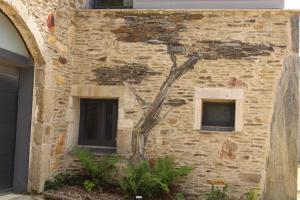 a brick building with a tree growing out of it at Domaine Paysager de Kertanguy in Garlan