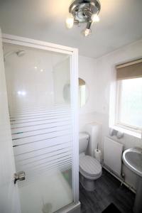 a bathroom with a shower and a toilet and a sink at 3 Bed Detached - Sleeps 5 - Private Garden & Parking Plus Garage - Quiet Cul De Sac Location - Dog Friendly - Fast Wifi - Close to Motorway Access in Doncaster +25 photos