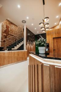 a lobby with a staircase and a brick wall at N9 Hotels in Nürnberg
