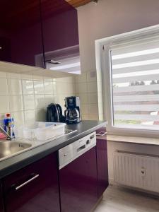 a kitchen with a sink and a window in it at 2- Zimmer Wohnung in Lehrte