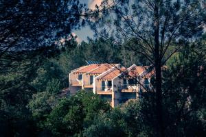 a house on top of a hill with trees at Quinta Camarena in Cercal