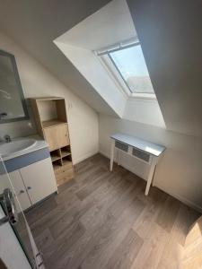 an attic room with a sink and a skylight at Duplex 4 personnes, ARMADA 2023 in Boos