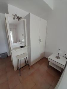 a bathroom with a sink and a stool and a mirror at St George's House in Potistika