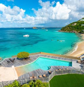 an aerial view of a swimming pool and the ocean at Grand Case Beach Club in Grand Case