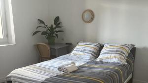 a bed with a stuffed animal on it in a bedroom at louisiana in Tercis-les-Bains