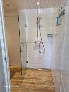 a shower with a glass door in a bathroom at 't Achterhuis 
