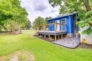 a blue tiny house with a deck on a yard at Cozy Hikers Hideaway Steps From Creeper Trail! in Damascus