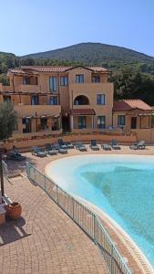 a resort with a swimming pool and a building at Pergola n.3 in Cavo