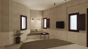 a bedroom with a bed and two windows at Meroviglia Boutique Hotel in Imerovigli