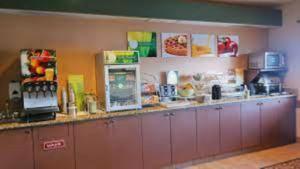 a kitchen with a counter with a refrigerator and a counter sidx sidx at Quality Inn & Suites Loveland in Loveland