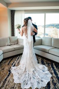 a bride and groom standing in front of a window at The Landing Hotel at Rivers Casino Pittsburgh in Pittsburgh