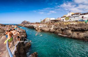 a group of people swimming in a body of water at La Bouganvilla in Garachico