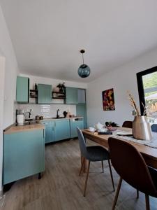 a kitchen with blue cabinets and a wooden table at Once Upon a Time in Montenegro in Sutomore