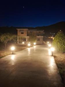 a driveway lit up with lights at night at Central House 1 in Ancient Epidauros