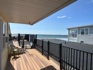 a porch with a balcony with a view of the beach at Abellona Inn & Suites in Old Orchard Beach