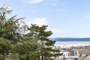 a view of a city with a tree in the foreground at Lofty Studio Prime Cap Hill Area Mins to Downtown in Seattle