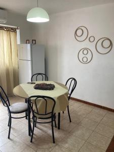 a kitchen with a table and chairs and a refrigerator at Pacífico Il in Cordoba