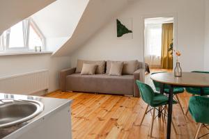 a living room with a couch and a table at TREND HOUSE Apartments in Vinnytsya
