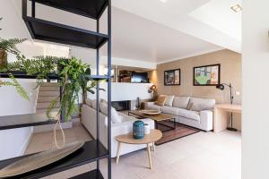 a living room with a couch and a table at BmyGuest - Vilamoura Marina's View in Vilamoura