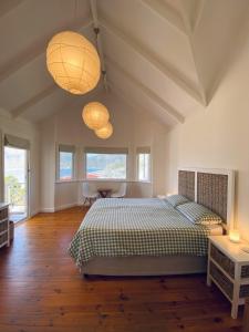 a bedroom with two lamps and a bed and a table at Villa Amanzi in Hout Bay