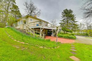 a large yellow house with a porch and a driveway at Charming Canandaigua Lake House w/ Deck & Views! in Rushville