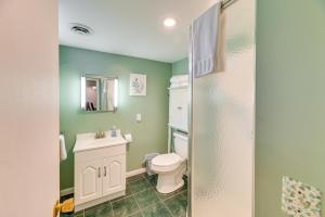 a bathroom with a toilet and a sink at Charming Canandaigua Lake House w/ Deck & Views! in Rushville +20 photos