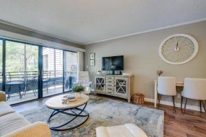 a living room with a couch and a table and a tv at Serene Myrtle Beach Condo with Resort Amenities! in Myrtle Beach