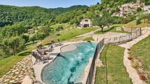 an aerial view of a swimming pool in a river at Ribosto in Molazzana