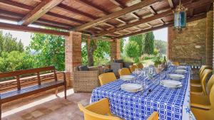 a table with a blue table cloth on a patio at Casale Conte Jacopo 10 in Magione