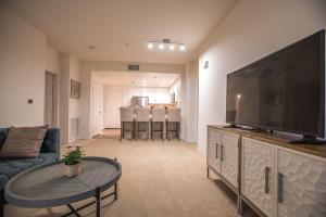 a living room with a large flat screen tv at Irvine Spectrum/2 Bedrooms/2 Bathrooms/Apartment/pool/gym in Irvine