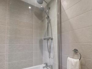 a shower with a glass door in a bathroom at 1 The Old Chapel in Otley