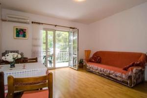 a living room with a couch and a table at Apartments Dalibor in Brna