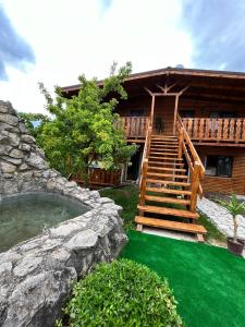 a house with a staircase and a green yard at Sunset Expanse in Turda