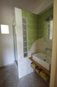 a bathroom with a sink and a shower at Chambres d'Hôtes Carpe Diem in Callian