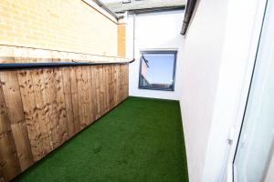 a hallway with green flooring in a building at Church Street Apartments in Hartlepool