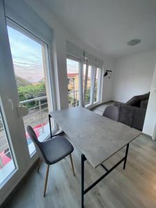 a dining room with a table and a couch at UpART House in Petrovac na Moru