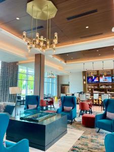 a lobby of a hotel with chairs and a table at The Landing Hotel at Rivers Casino Pittsburgh in Pittsburgh