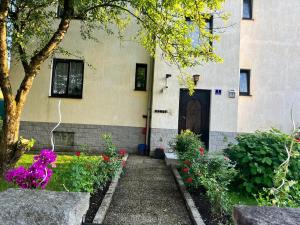 a building with a door and flowers in front of it at Pension DonauBlick Grein 1 , Spitzfeldstr 1 in Grein