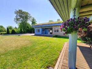 a porch with a pot of flowers on a house at George Holiday Home in Nasva