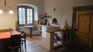 a kitchen with a table and a dining room at Schloss Höllrich in Karsbach +13 photos