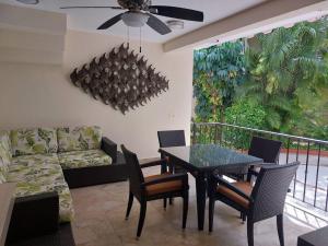 a living room with a table and chairs and a couch at Villas Cozumel #8 in Cozumel