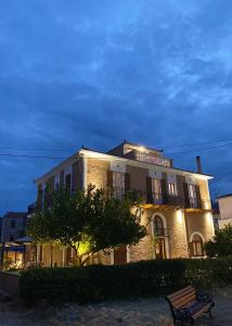 a building with a bench in front of it at Pension Hirolakas in Galaxidhion