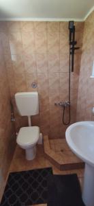 a bathroom with a toilet and a sink at Penthouse Studio next to the Sea in Salamís