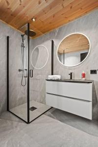 a bathroom with a shower and a sink and a mirror at Tonningssætra Mountain Lodge in Stryn
