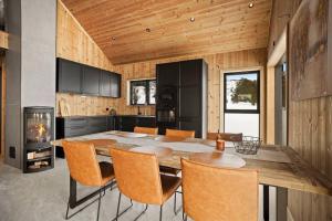 a kitchen with a table and chairs and a fireplace at Tonningssætra Mountain Lodge in Stryn