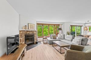 a living room with a couch and a fireplace at Ski Inout 2brs On The Mountain! 197-3 in Mont-Tremblant