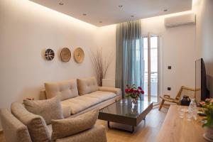 a living room with a couch and a table at Anasasmos House in Naxos Chora