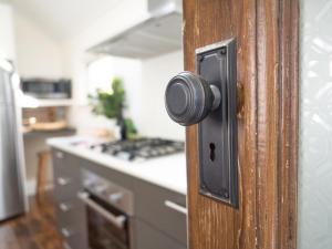 an open door to a kitchen with a stove at Cottage 79 in Orange